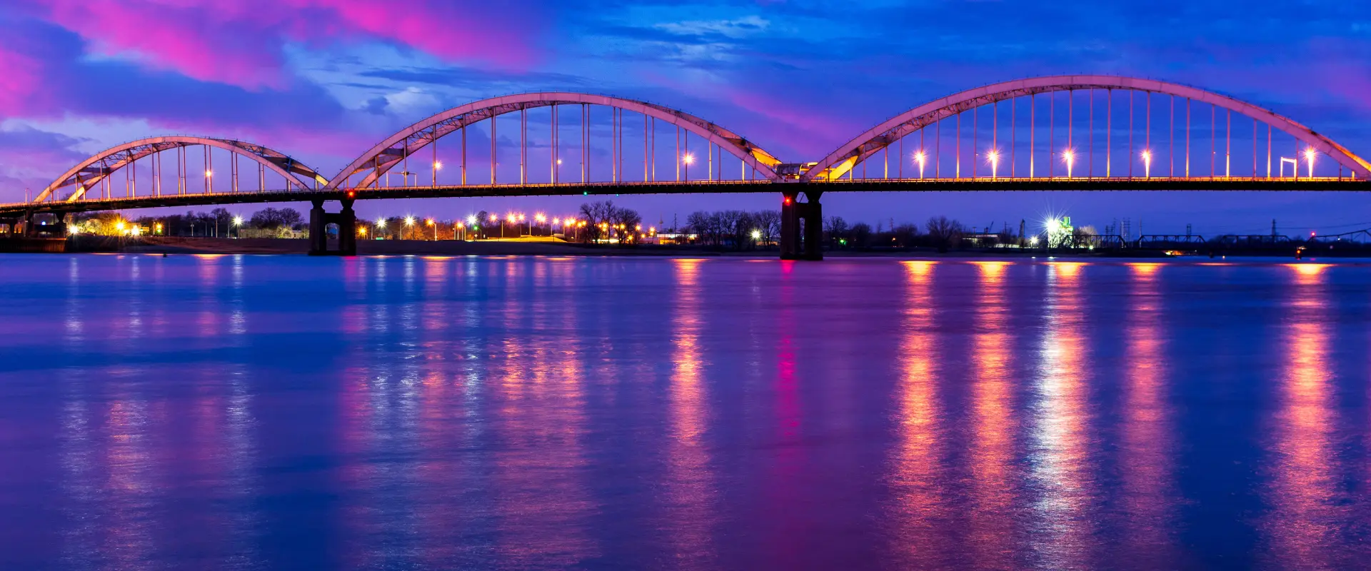 The Centennial Bridge lit at dusk over the Mississippi River at Davenport, Iowa